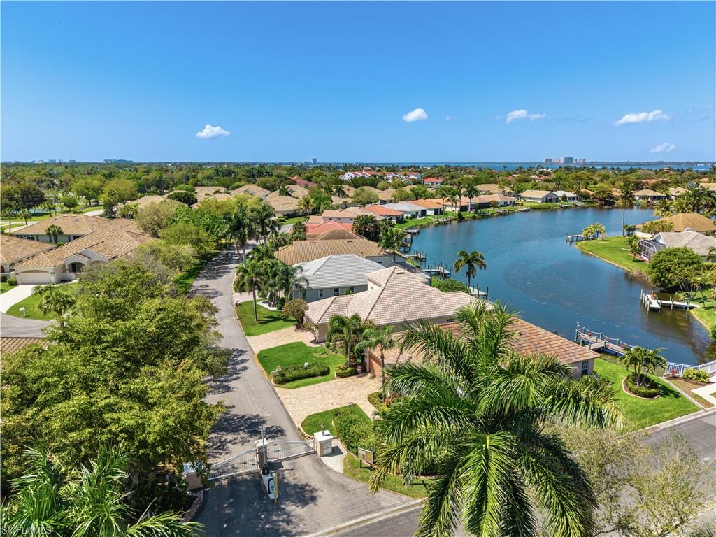 Aerial perspective of suburban area featuring a nearby body of water