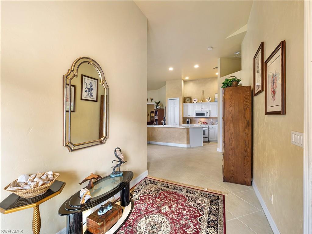 Hallway featuring light tile patterned flooring and recessed lighting