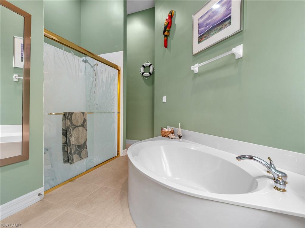 Bathroom featuring a garden tub and light tile patterned floors