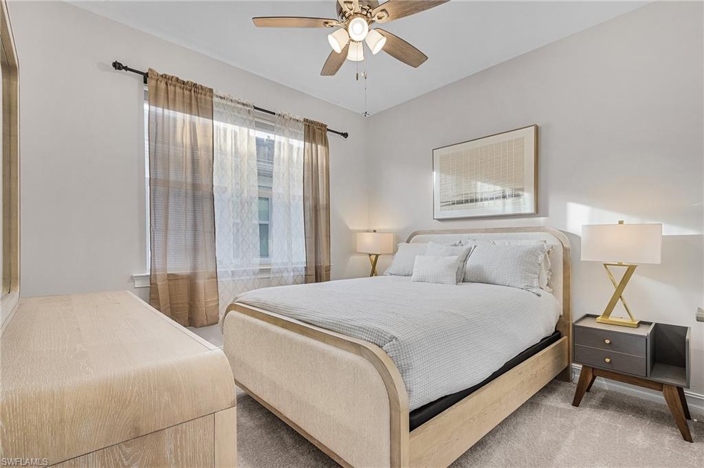 Carpeted bedroom with ceiling fan