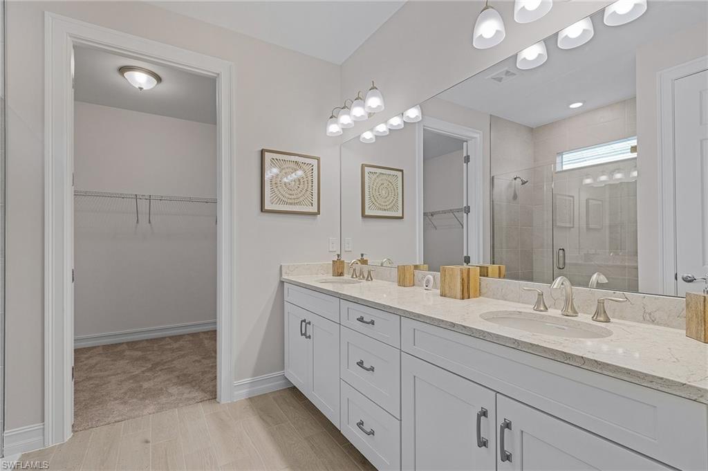 Bathroom featuring vanity, an enclosed shower, and hardwood / wood-style flooring