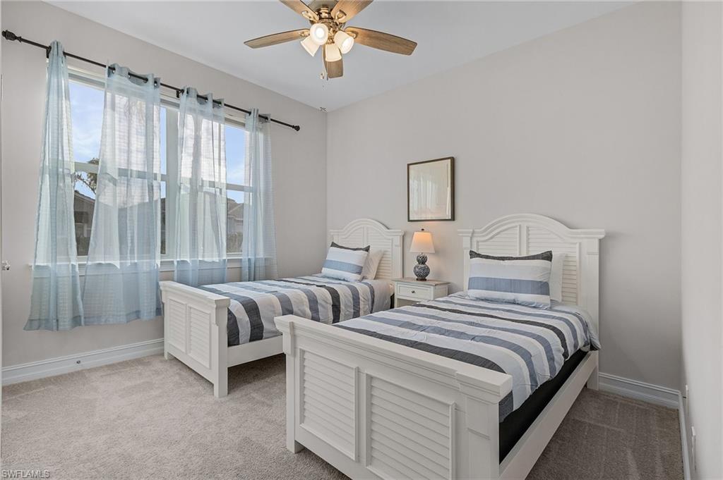 Bedroom featuring ceiling fan and light carpet