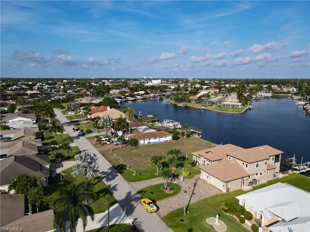 Aerial perspective of suburban area featuring a large body of water