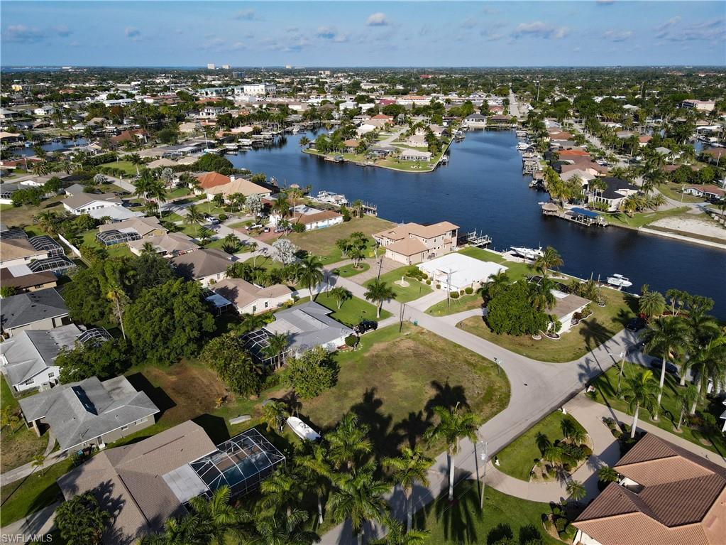 Aerial view of property's location with nearby suburban area and a nearby body of water