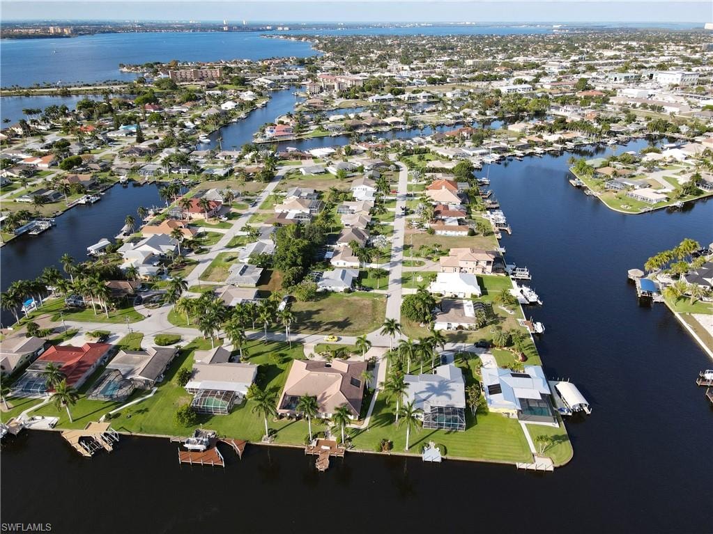 Aerial overview of property's location with a large body of water and nearby suburban area