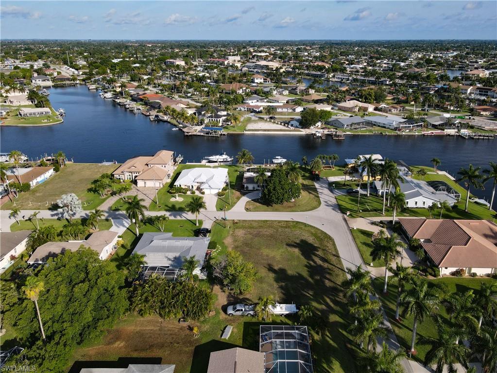 Aerial overview of property's location with nearby suburban area and a nearby body of water