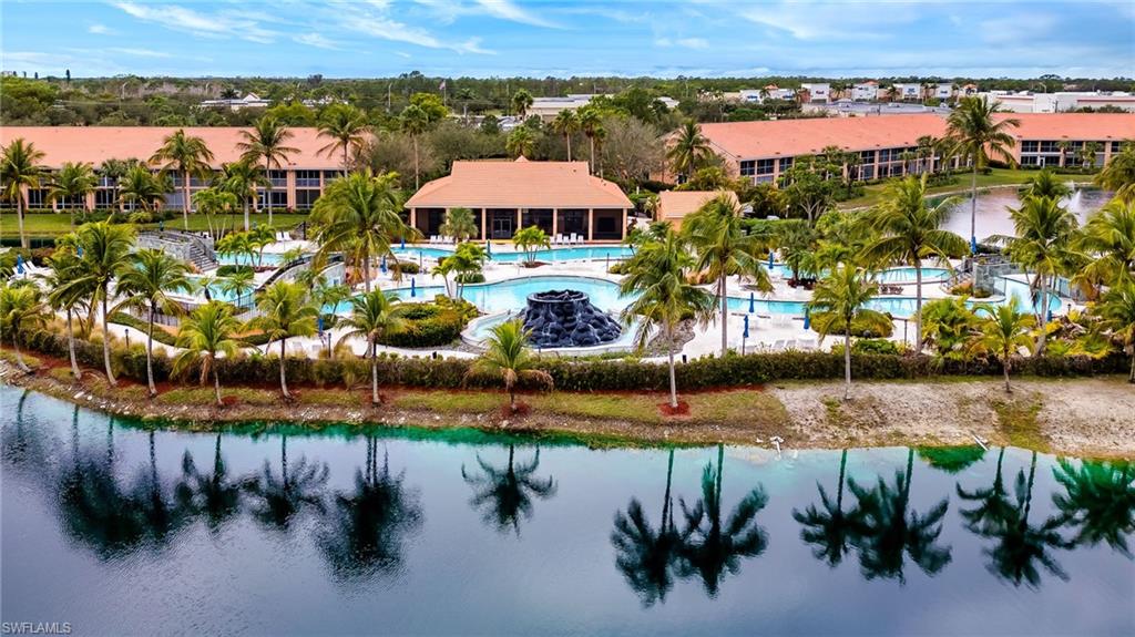 Aerial view of a pool and a nearby body of water
