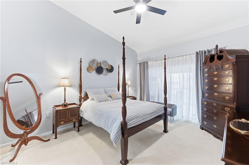 Bedroom with lofted ceiling, light colored carpet, and ceiling fan