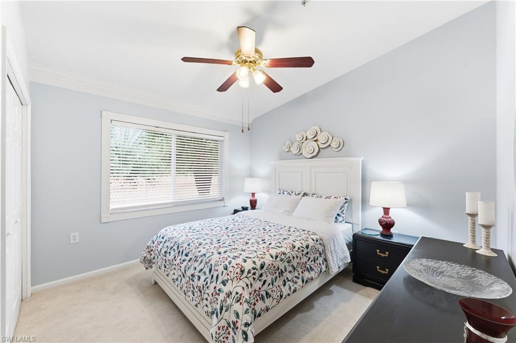 Bedroom with light carpet, a ceiling fan, a closet, and lofted ceiling