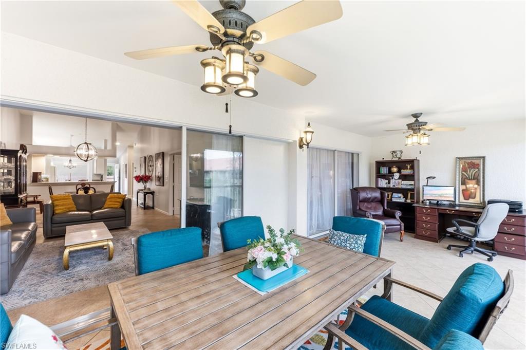 Tiled dining room featuring suspended lighting, an office area, and ceiling fan