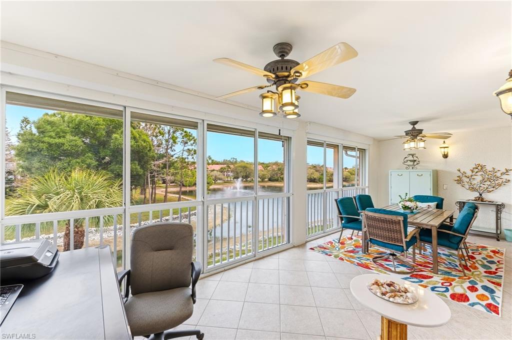 Sunroom / solarium featuring a water view and tile patterned flooring