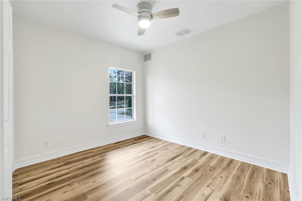 Empty room with light wood-type flooring and a ceiling fan