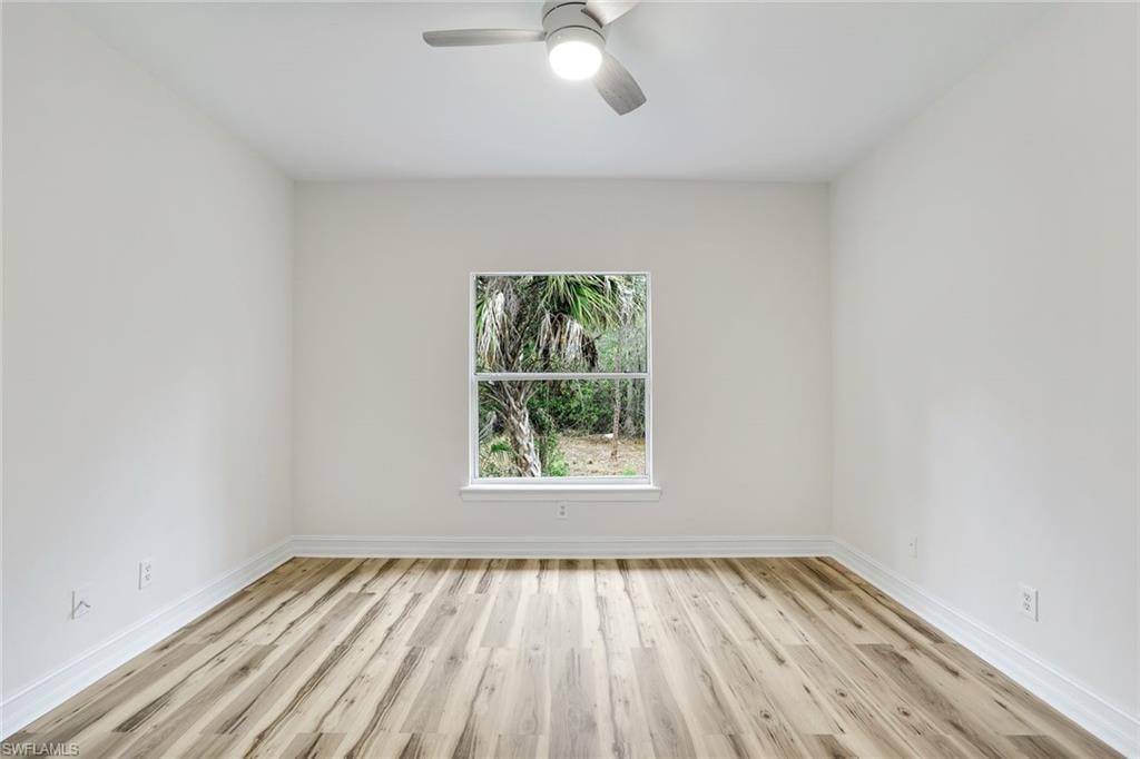 Spare room with light wood-type flooring and ceiling fan