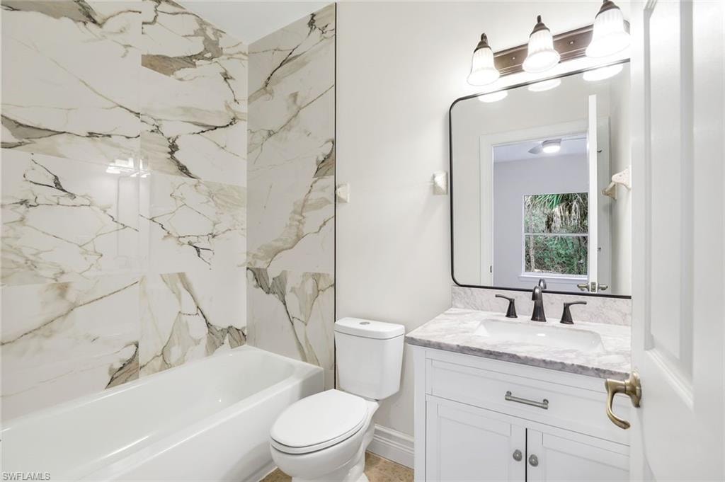 Bathroom featuring vanity and shower / bath combination