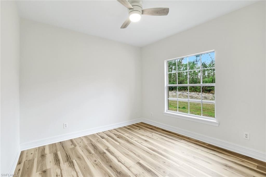 Spare room featuring light wood-style flooring and a ceiling fan