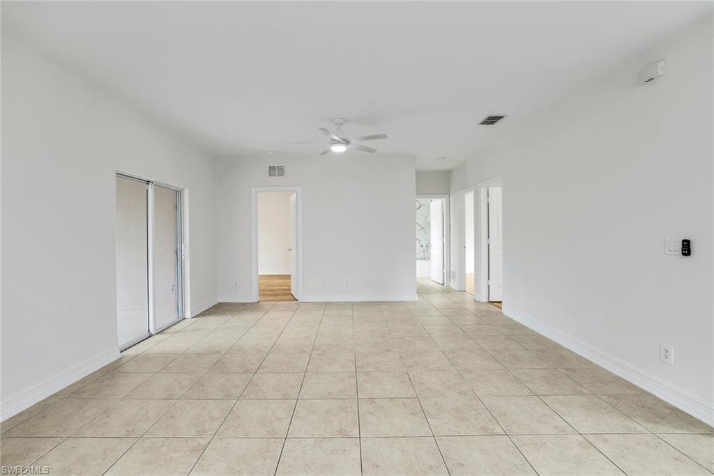 Unfurnished room featuring a ceiling fan and light tile patterned floors