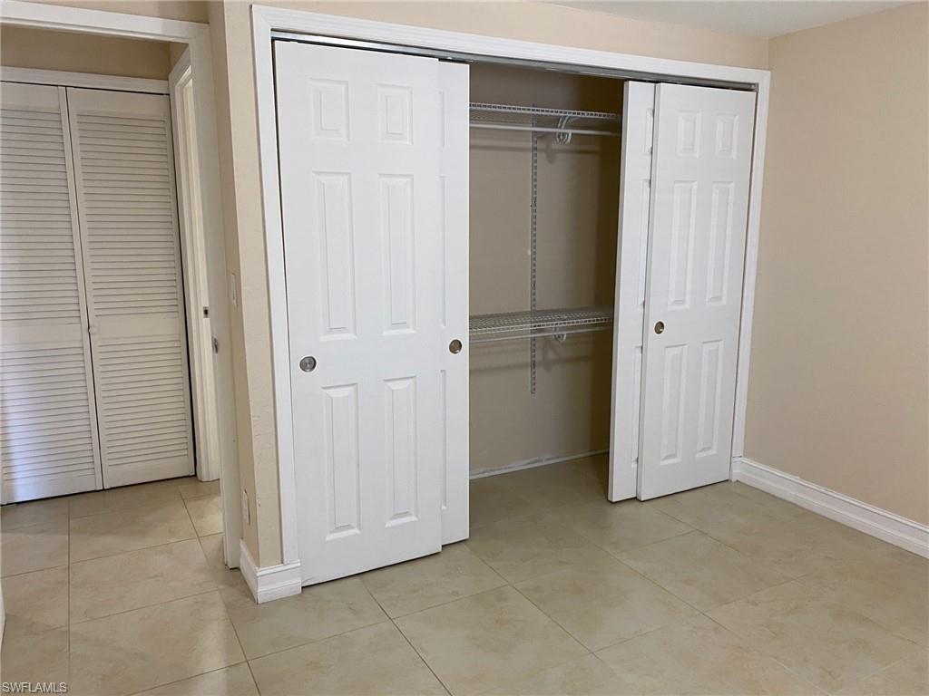 Unfurnished bedroom featuring light tile patterned floors and a closet
