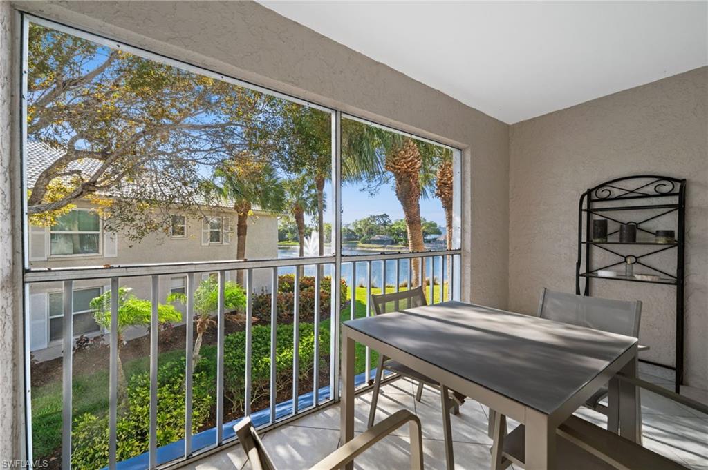 Balcony featuring a sunroom, a water view, and outdoor dining area