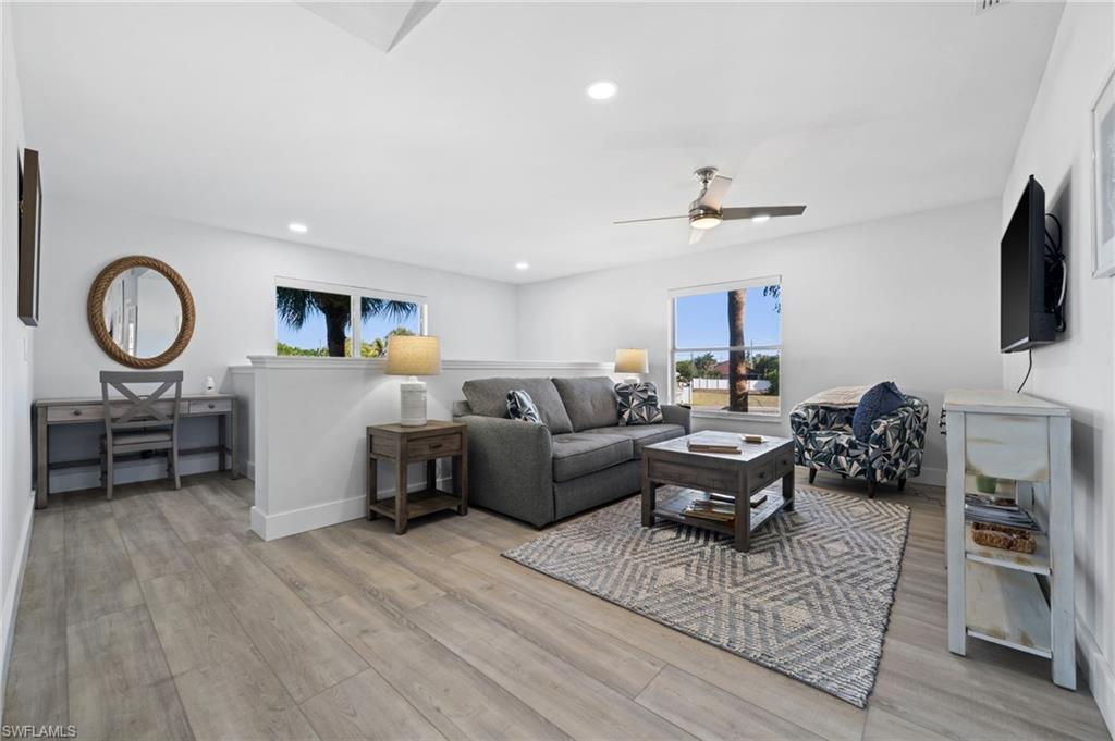 Living area with light wood-type flooring, recessed lighting, and ceiling fan