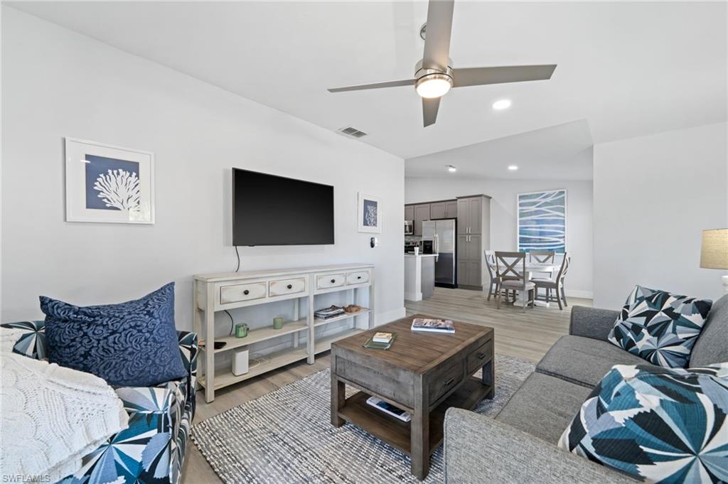Living room with a ceiling fan and light wood-style floors