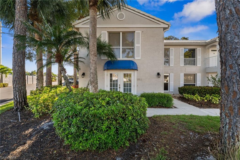 View of front of property with stucco siding and french doors