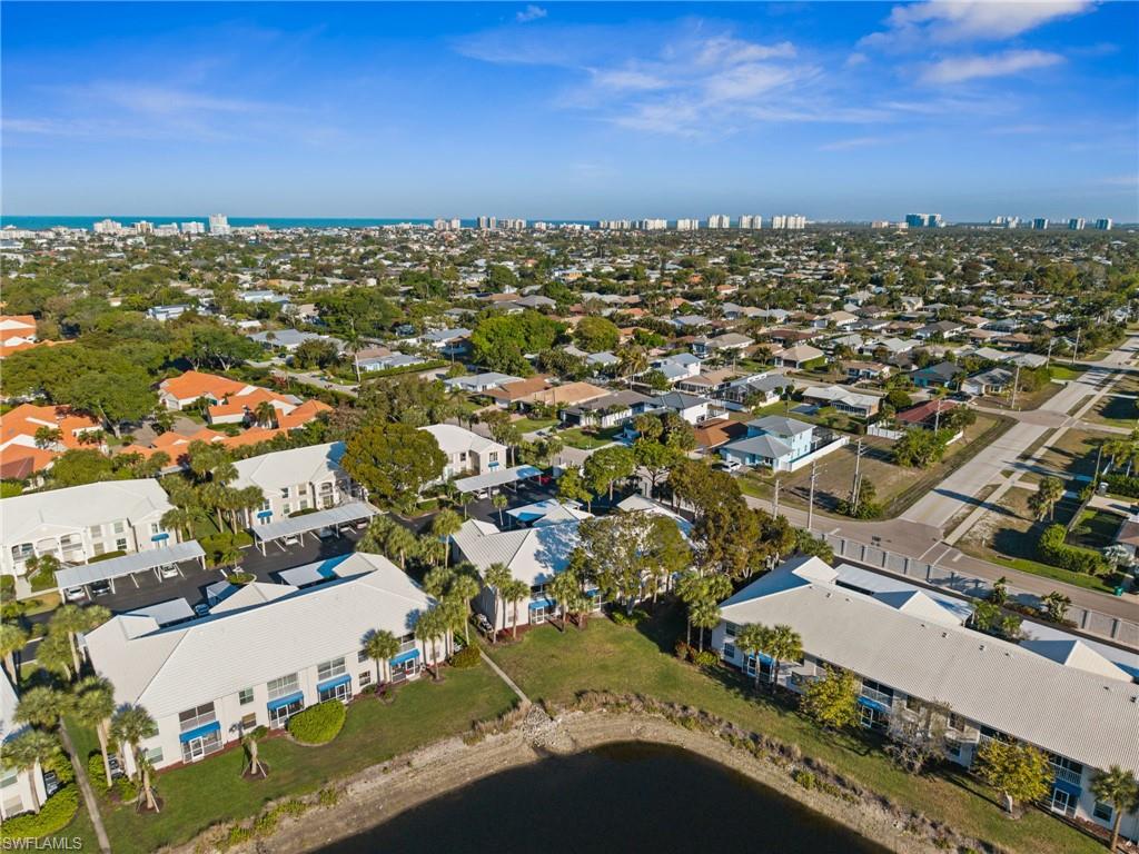 Aerial view of property and surrounding area with a large body of water and skyline