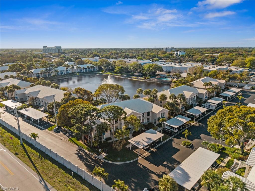 Aerial perspective of suburban area featuring a nearby body of water