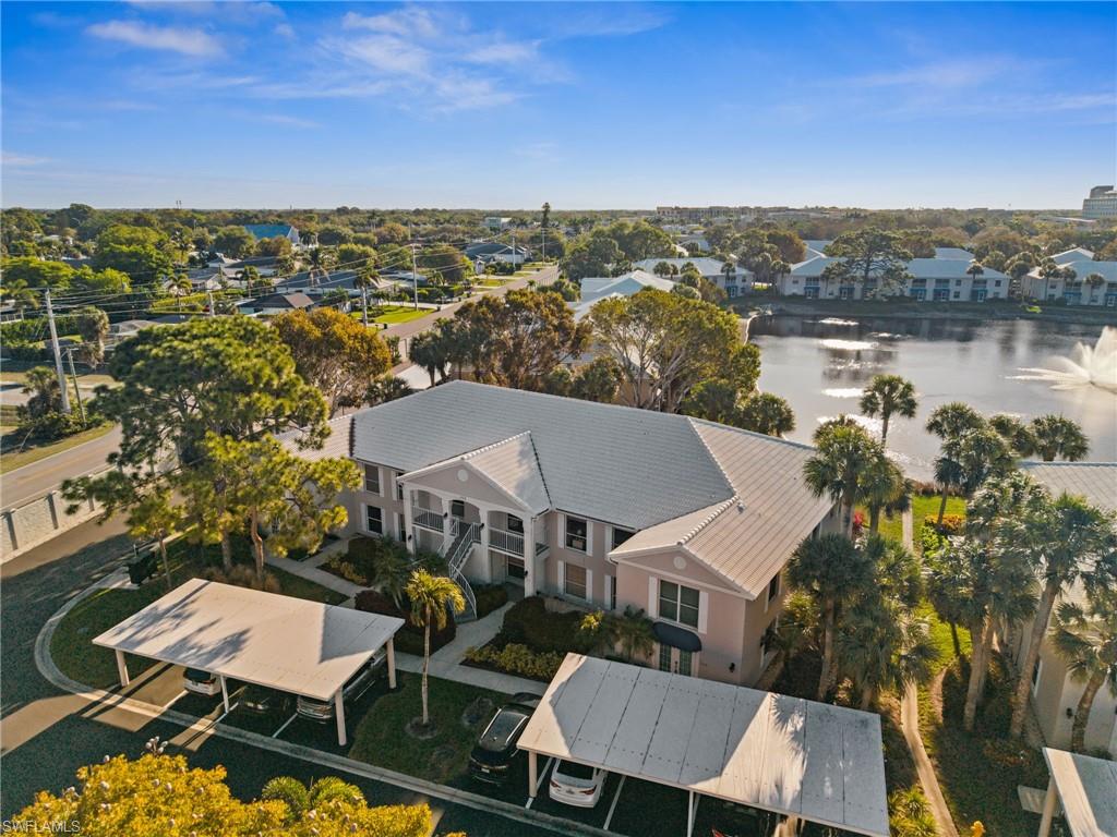 Aerial perspective of suburban area featuring a nearby body of water