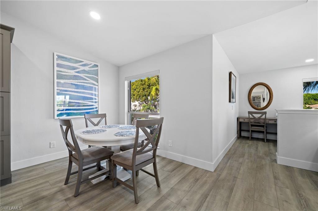 Dining area with vaulted ceiling, recessed lighting, and light wood finished floors