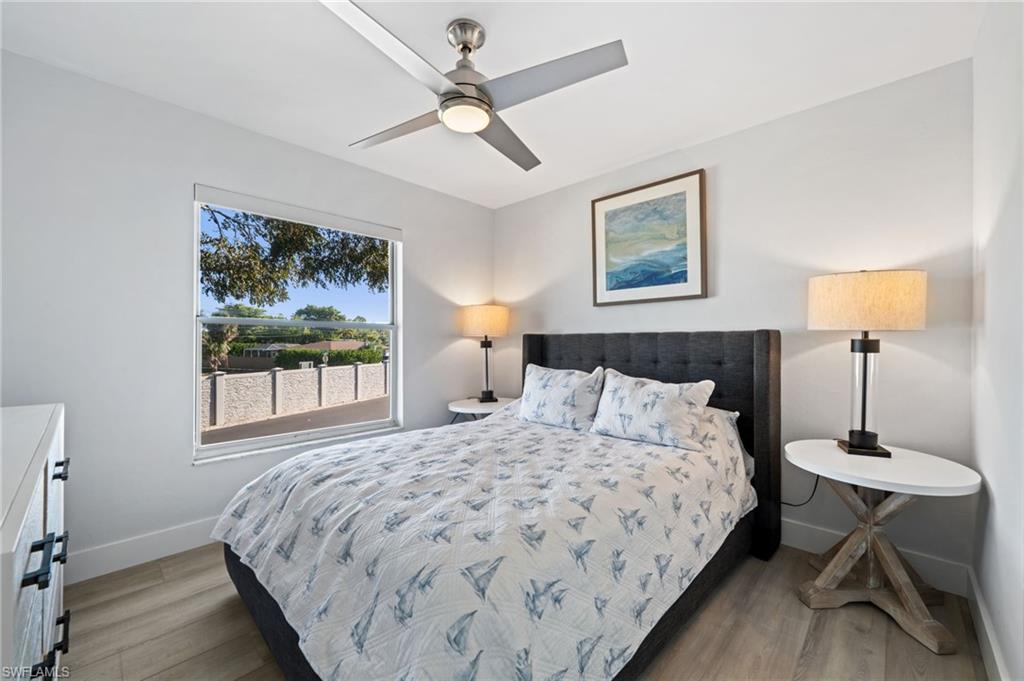 Bedroom with light wood-style flooring and a ceiling fan