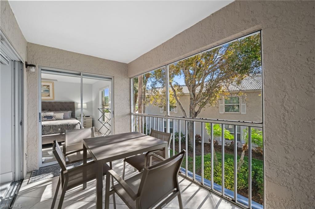 Sunroom / solarium with outdoor dining space and a balcony