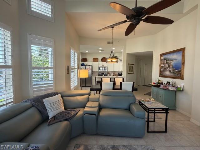 Living area with ceiling fan and a high ceiling