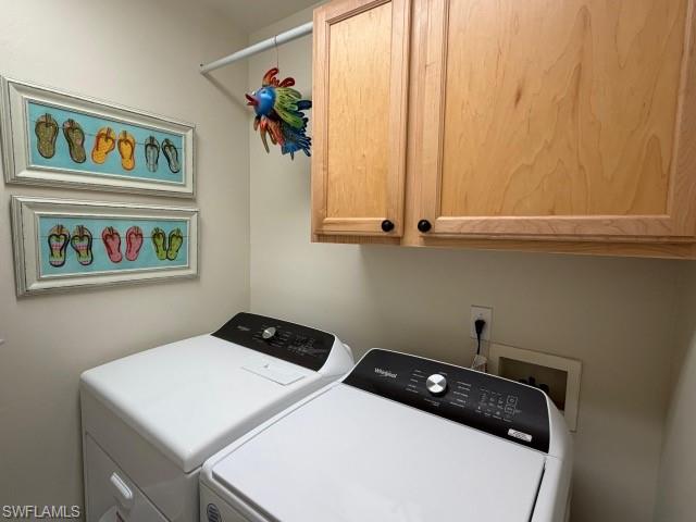 Laundry room featuring cabinet space and independent washer and dryer