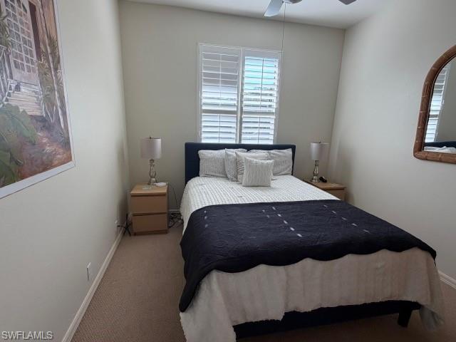 Carpeted bedroom with baseboards and ceiling fan