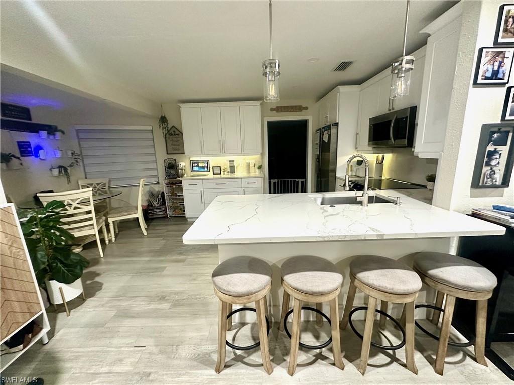 beautiful updated kitchen with quartz countertops and soft pull drawers