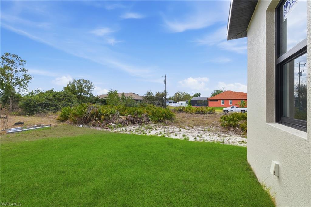 View of grassy yard with a residential view
