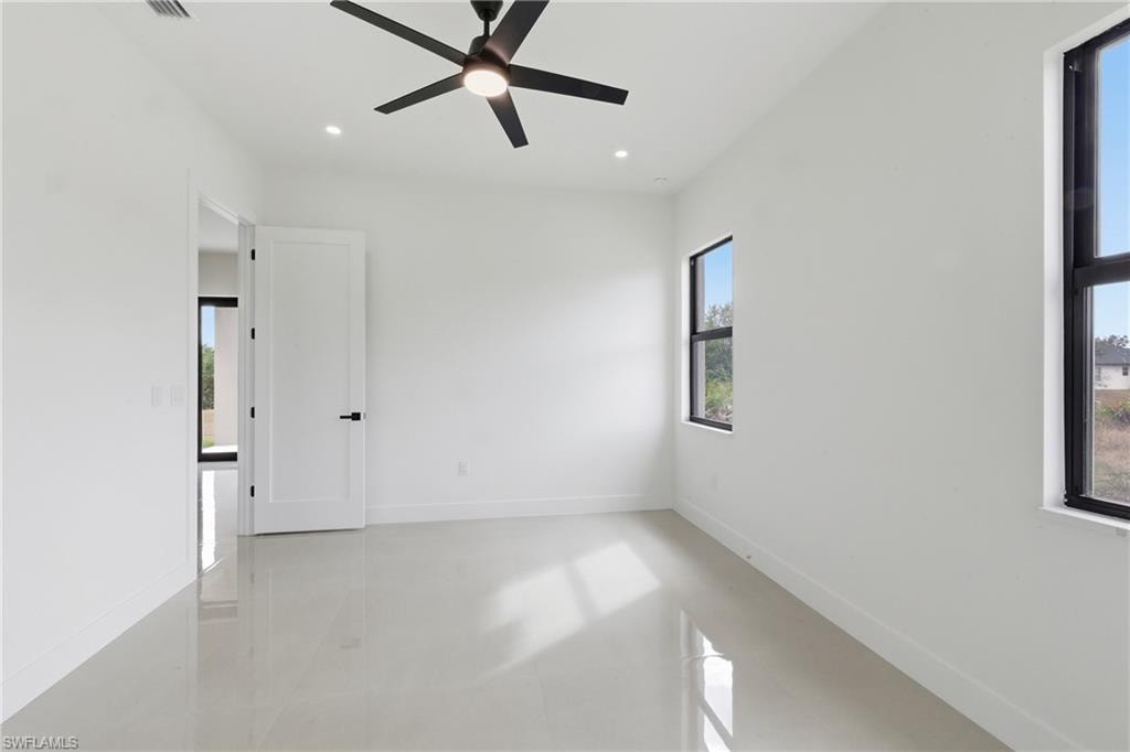Unfurnished room with ceiling fan, finished concrete floors, and recessed lighting