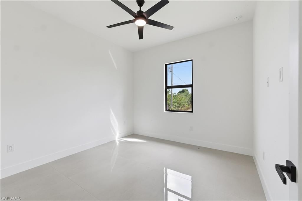Empty room with a ceiling fan and concrete floors