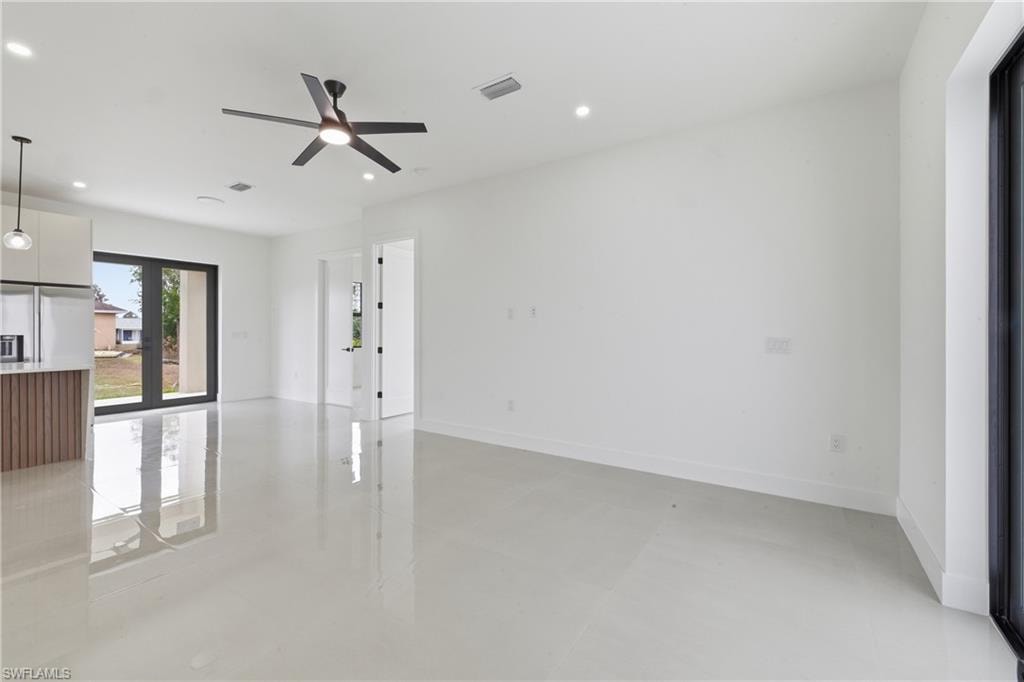 Unfurnished living room with concrete flooring, recessed lighting, and ceiling fan