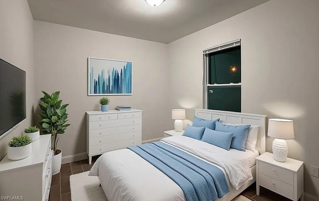 Bedroom with baseboards and wood tiled floors