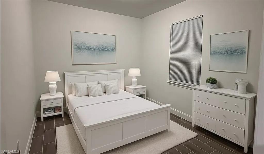 Bedroom featuring baseboards and wood finish floors