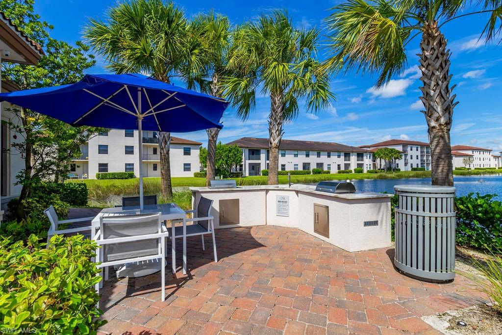 View of patio / terrace featuring an outdoor kitchen / dining area and a water view