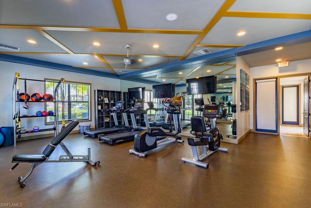 Workout area featuring coffered ceiling, ceiling fan, and recessed lighting