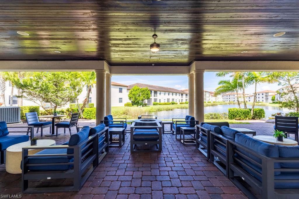 View of patio featuring an outdoor lounge area and a water view