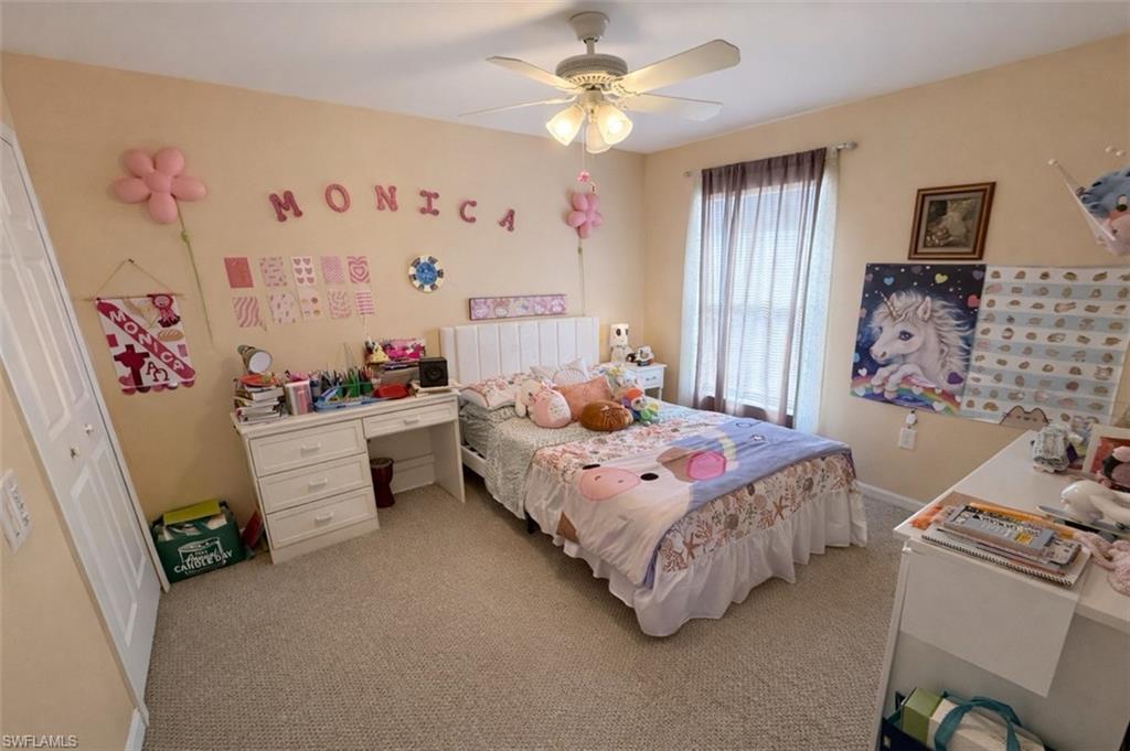 Bedroom featuring light colored carpet and a ceiling fan