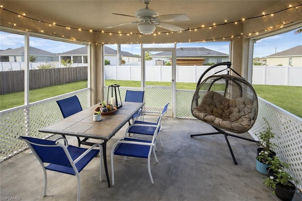Sunroom featuring ceiling fan, outdoor dining space, and healthy amount of natural light