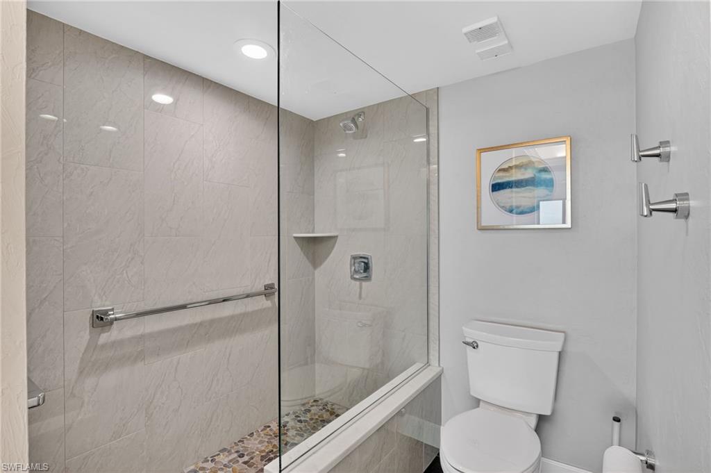 Bathroom with a shower stall and recessed lighting