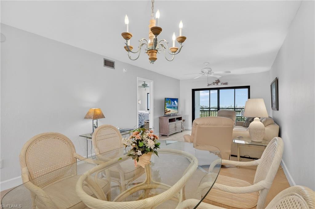 Dining room featuring ceiling fan and suspended lighting