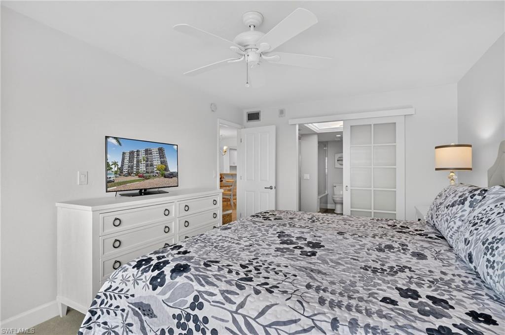 Bedroom featuring light colored carpet and a ceiling fan