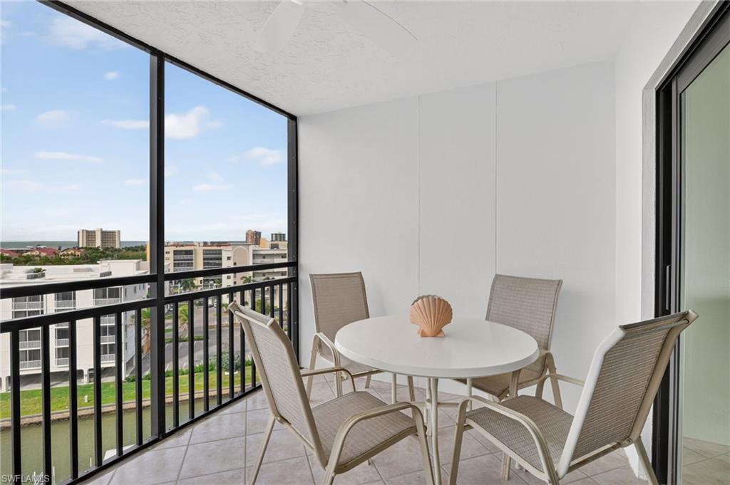 Balcony featuring a sunroom and a view of city